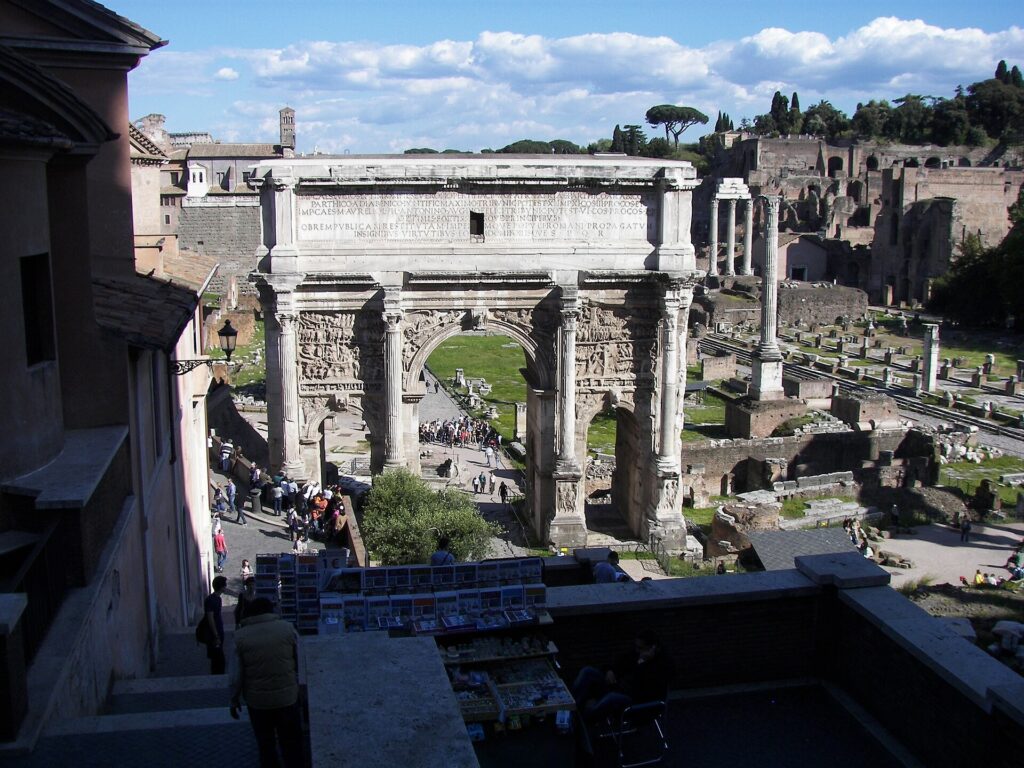 A triumphal arch among the ruins of the Roman Forum in Rome