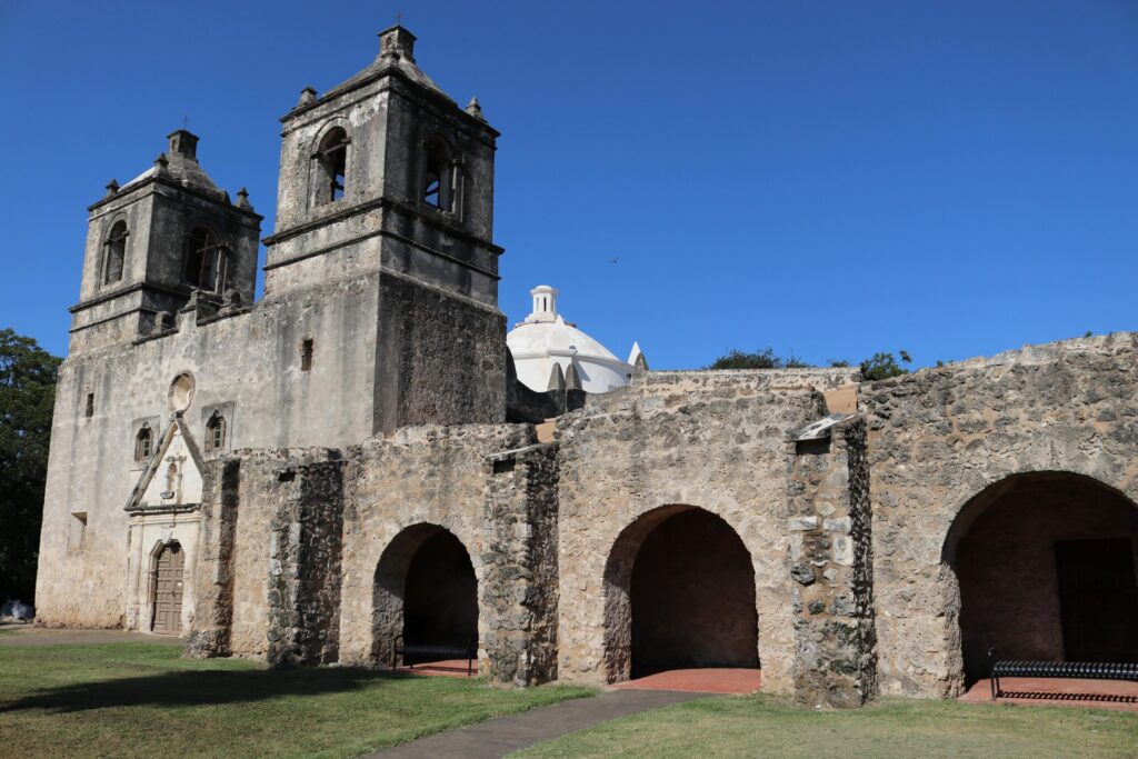 Mission Concepcion church with twin bell towers and arched convento at San Antonio Missions National Historical Park