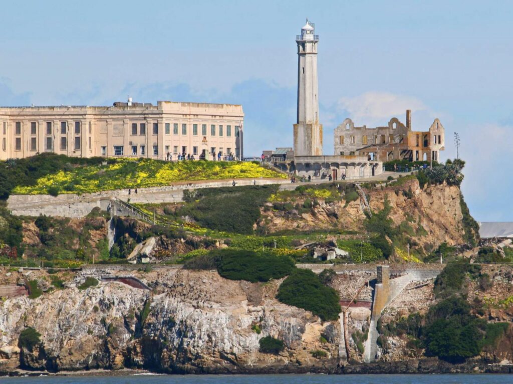 Alcatraz Island seen from the water with the cellhouse and water tower on the rock