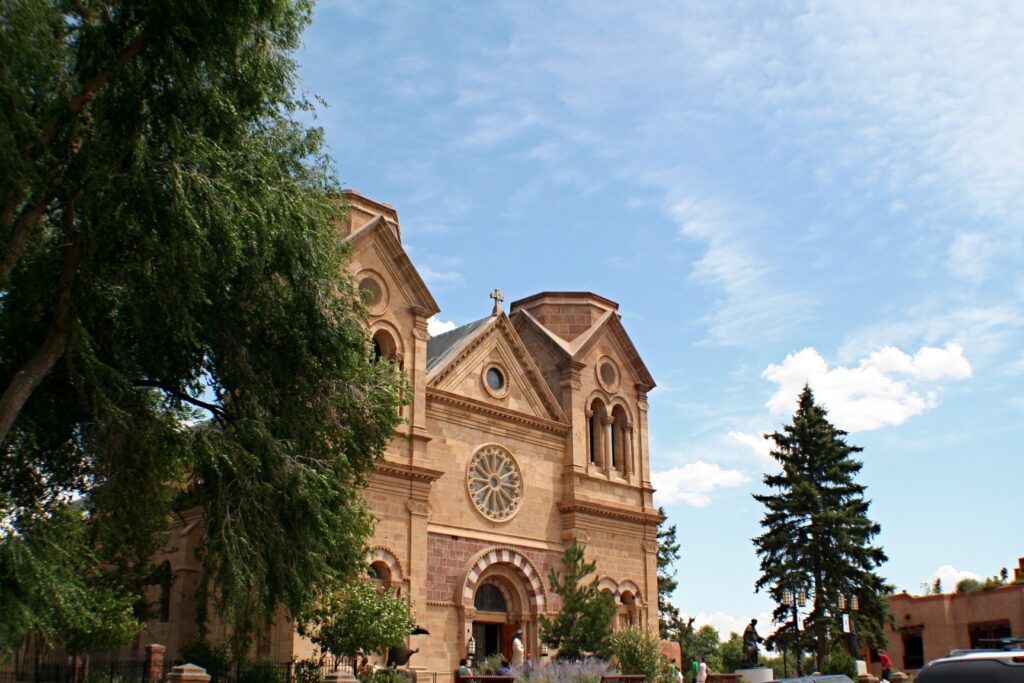 The Cathedral Basilica of St. Francis of Assisi seen through trees in Santa Fe, New Mexico