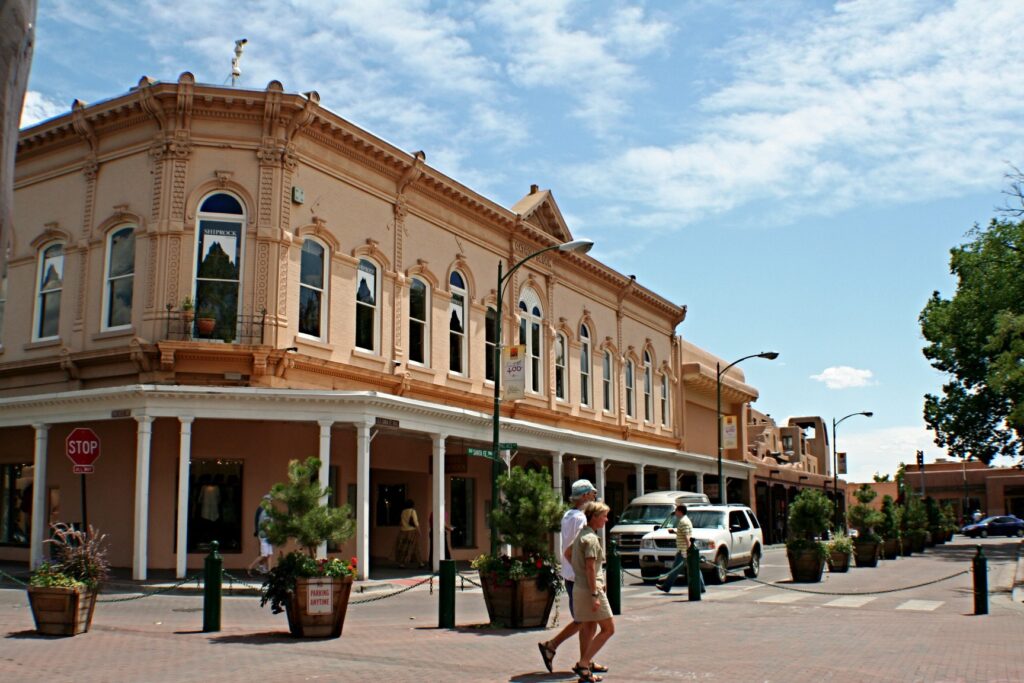 A two-story historic building with a covered porch just off the Plaza in downtown Santa Fe, New Mexico