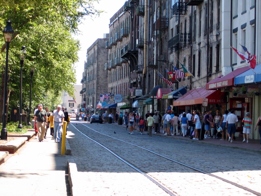 Brick and cobbled River Street in Savannah lined with old waterfront buildings
