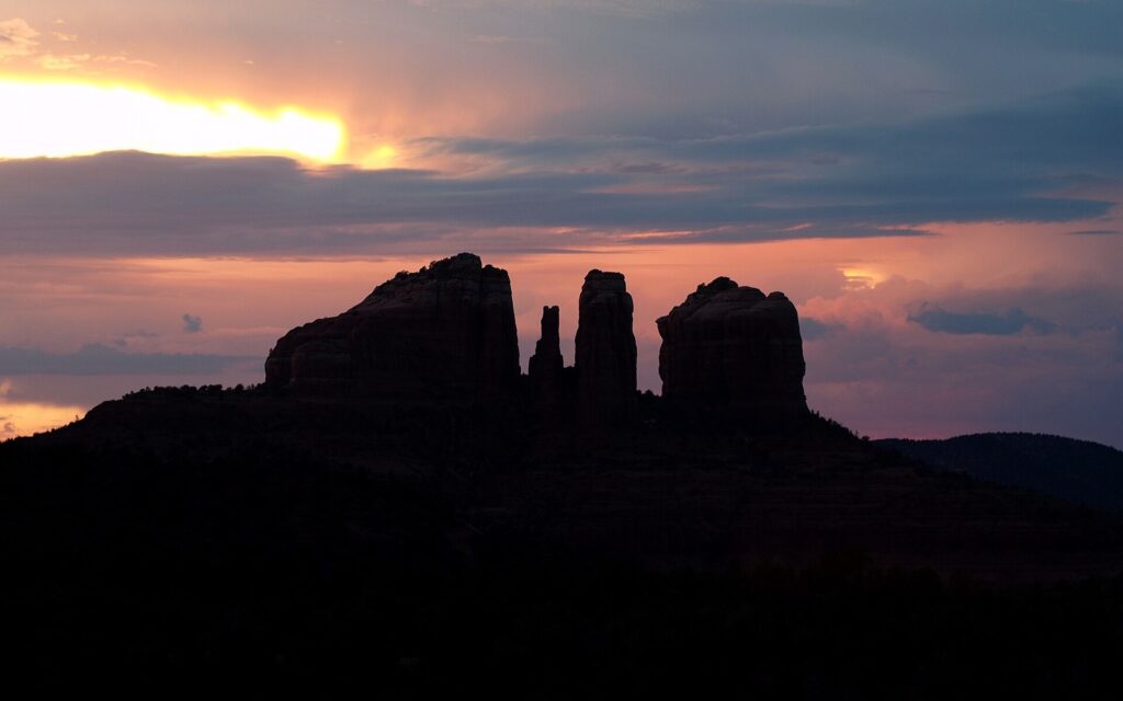 Cathedral Rock spires silhouetted against a sunset sky near Sedona, Arizona