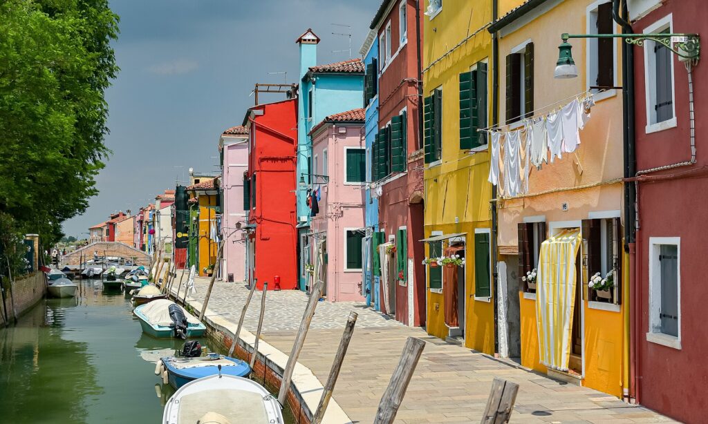 A canal lined with brightly painted houses on Burano island in the Venetian lagoon