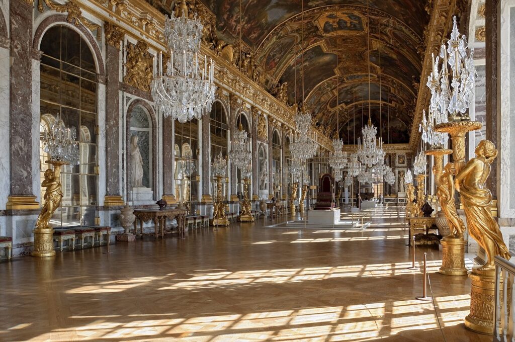Hall of Mirrors with its chandeliers and arched windows at the Palace of Versailles