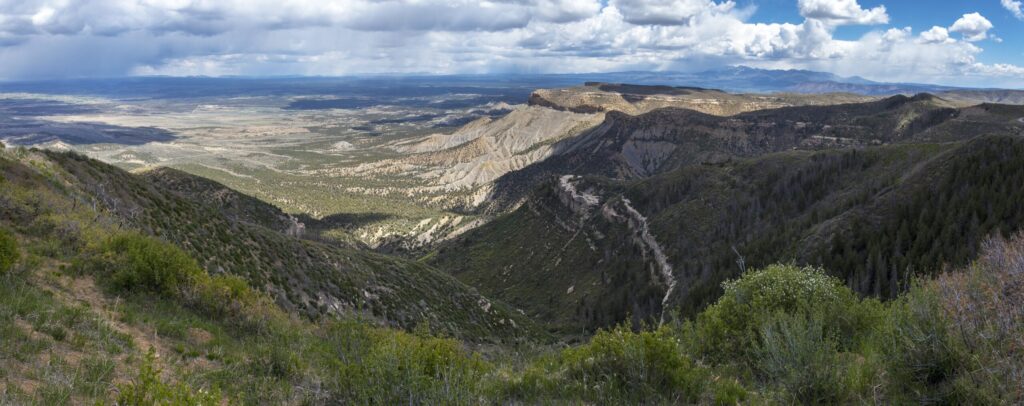 Wide view of green mesas and canyons from Park Point at Mesa Verde National Park