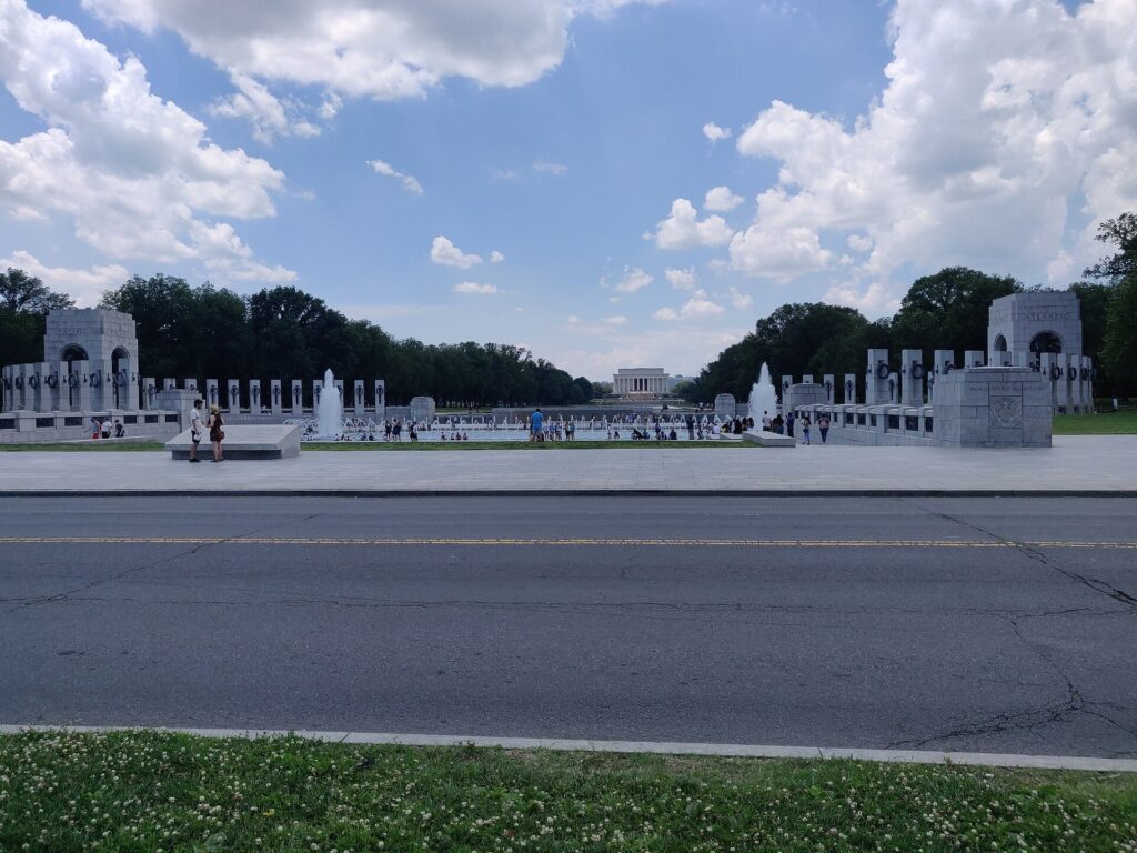World War II Memorial pillars and fountain seen across a road in Washington DC