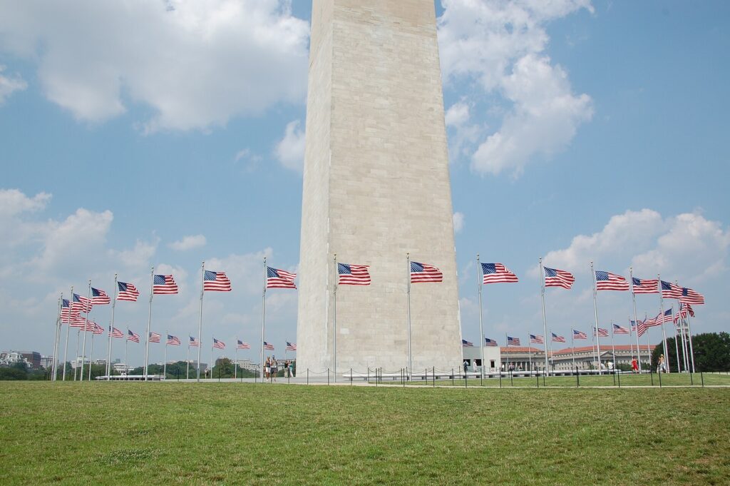 Base of the Washington Monument ringed by American flags on the National Mall