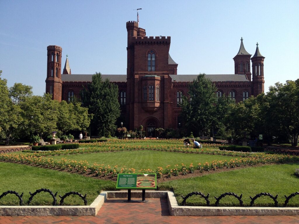 Red sandstone Smithsonian Castle behind the Haupt Garden parterre in Washington DC