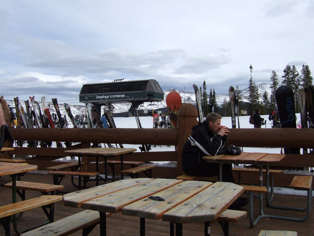 Skis racked on a mountain deck beside the Zephyr Express chairlift terminal at Winter Park, Colorado